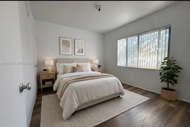 a bedroom with a bed and a potted plant