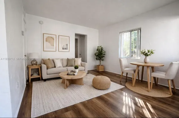 a living room with furniture and wooden floor