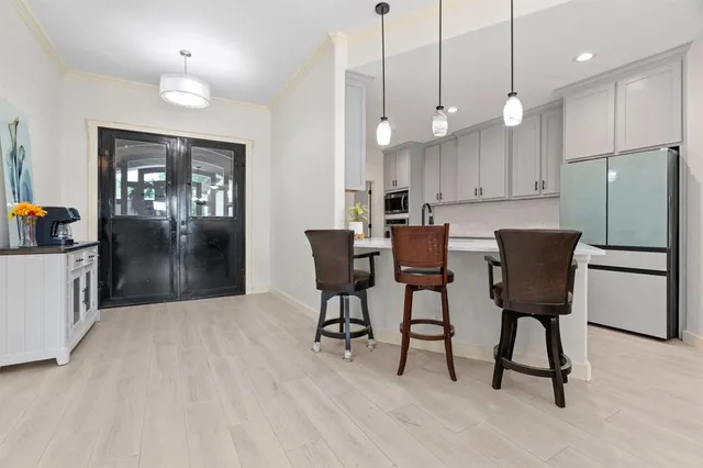 a view of kitchen with refrigerator and chair