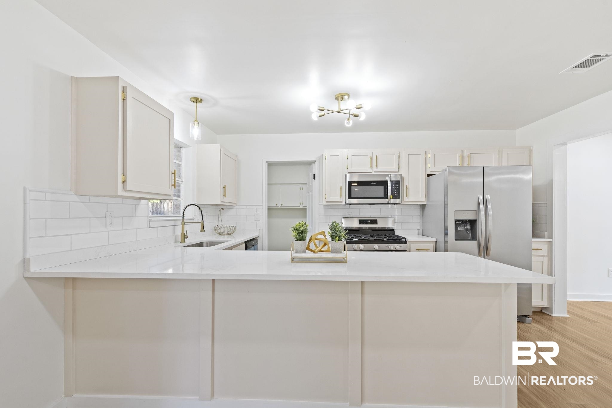 5398 Quail Run North Theodore, AL 36582 - Photo 11 of 46 Kitchen with white cabinets, kitchen peninsula, sink, and appliances with stainless steel finishes
