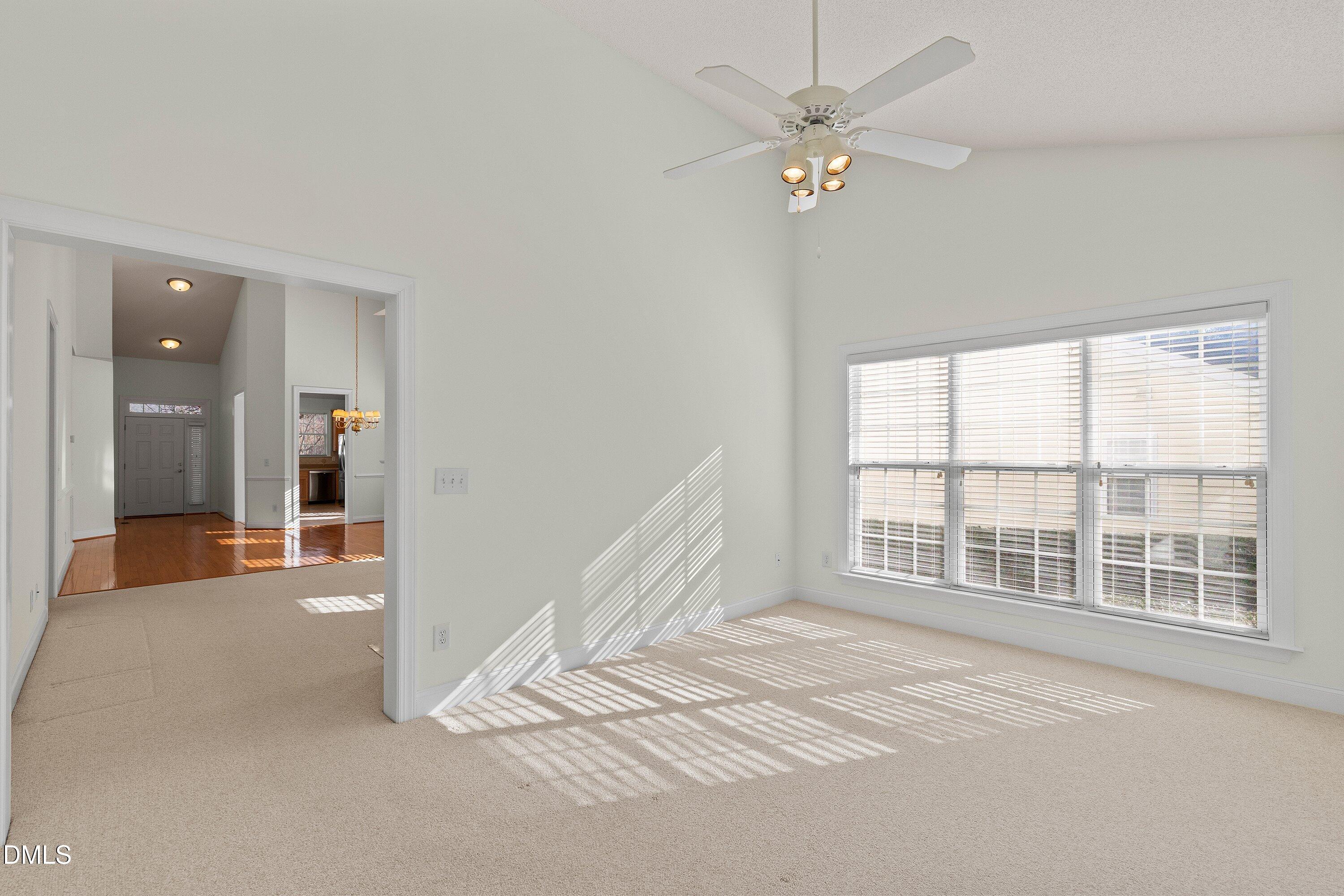 105 Rockport Ridge Way Cary, NC 27519 - Photo 23 of 43 an empty room with chandelier fan and windows