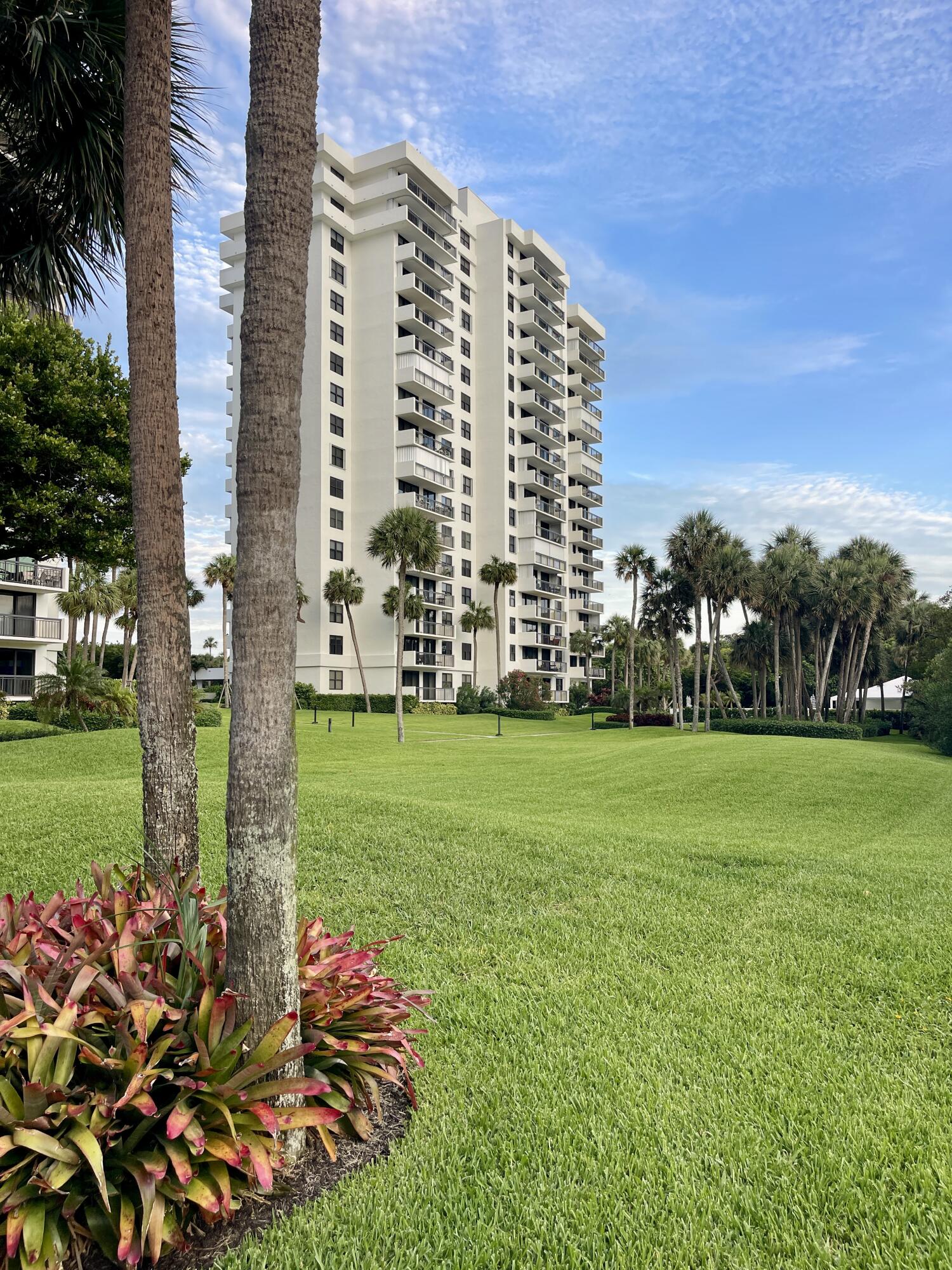 2001 North Ocean Boulevard, Unit 301 Boca Raton, FL 33431 - Photo 37 of 41 a view of a multi story residential apartment building with a yard