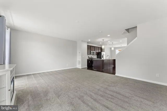 a view of a kitchen with a sink and refrigerator
