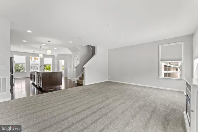 a view of a living room a dining room with wooden floor and a window