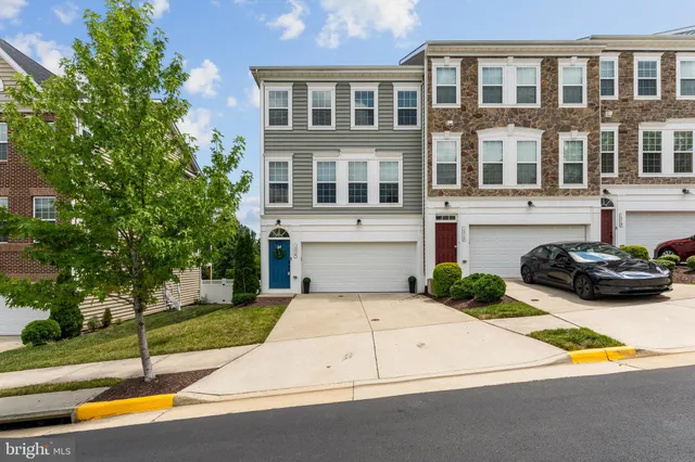 a view of a patio with a table and chairs under an umbrella