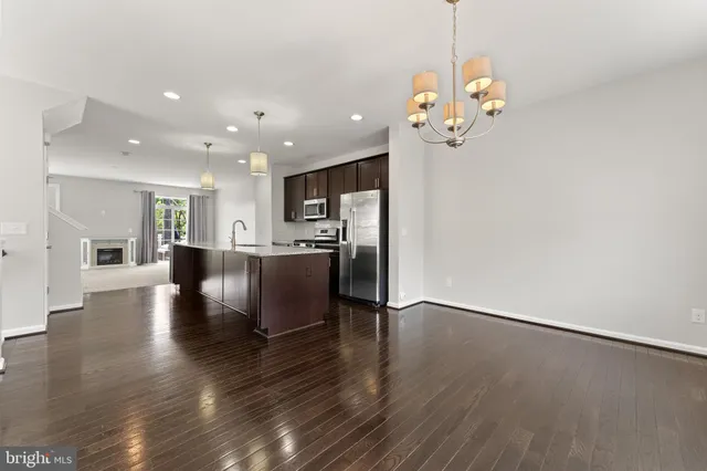 a view of a kitchen with furniture and wooden floor