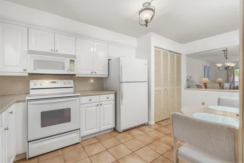 a kitchen with cabinets stainless steel appliances and counter space