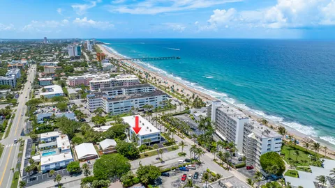 a living room with furniture and large windows