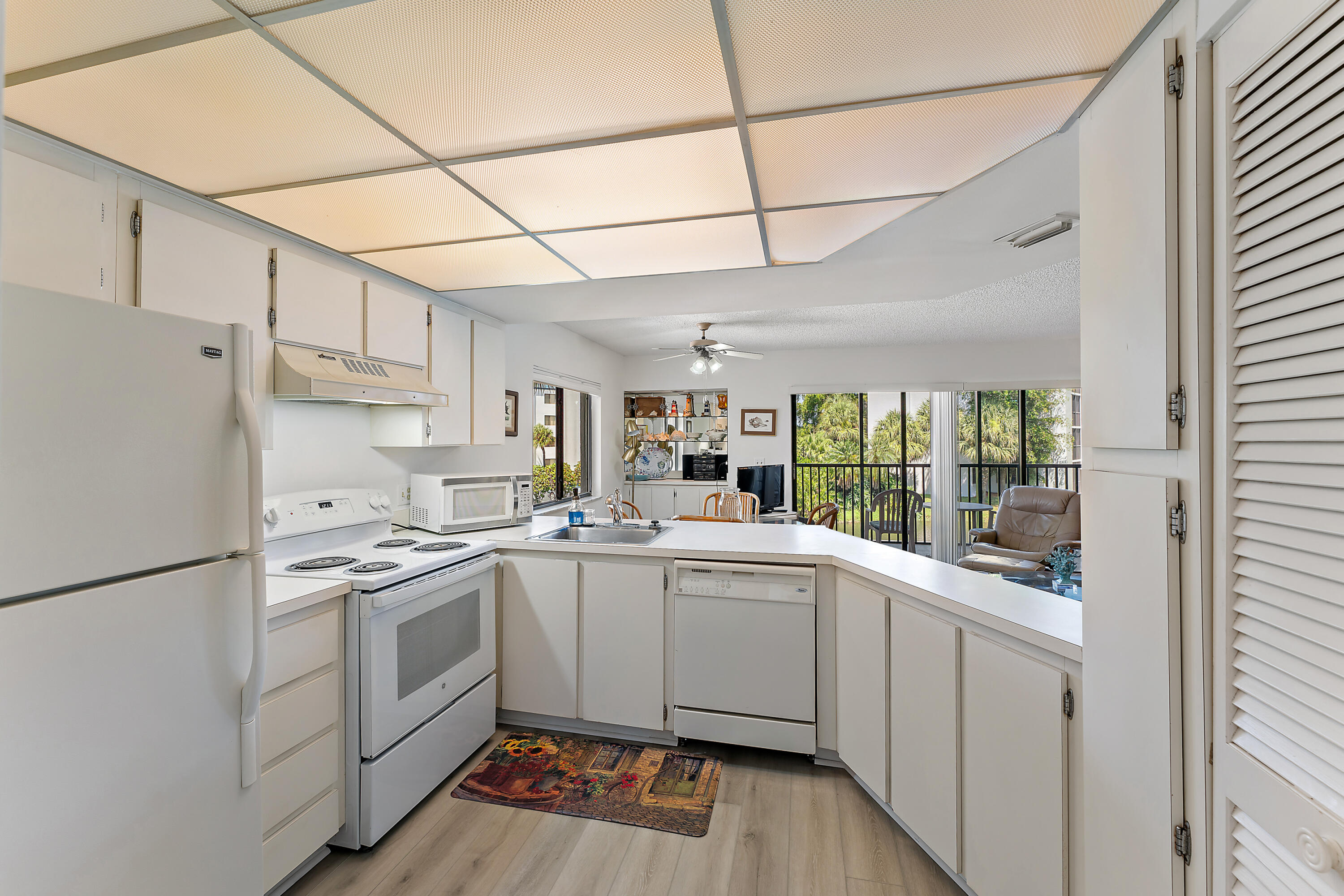 1605 Highway 1, Unit B201 Jupiter, FL 33477 - Photo 15 of 33 a kitchen with a sink cabinets stainless steel appliances and a window