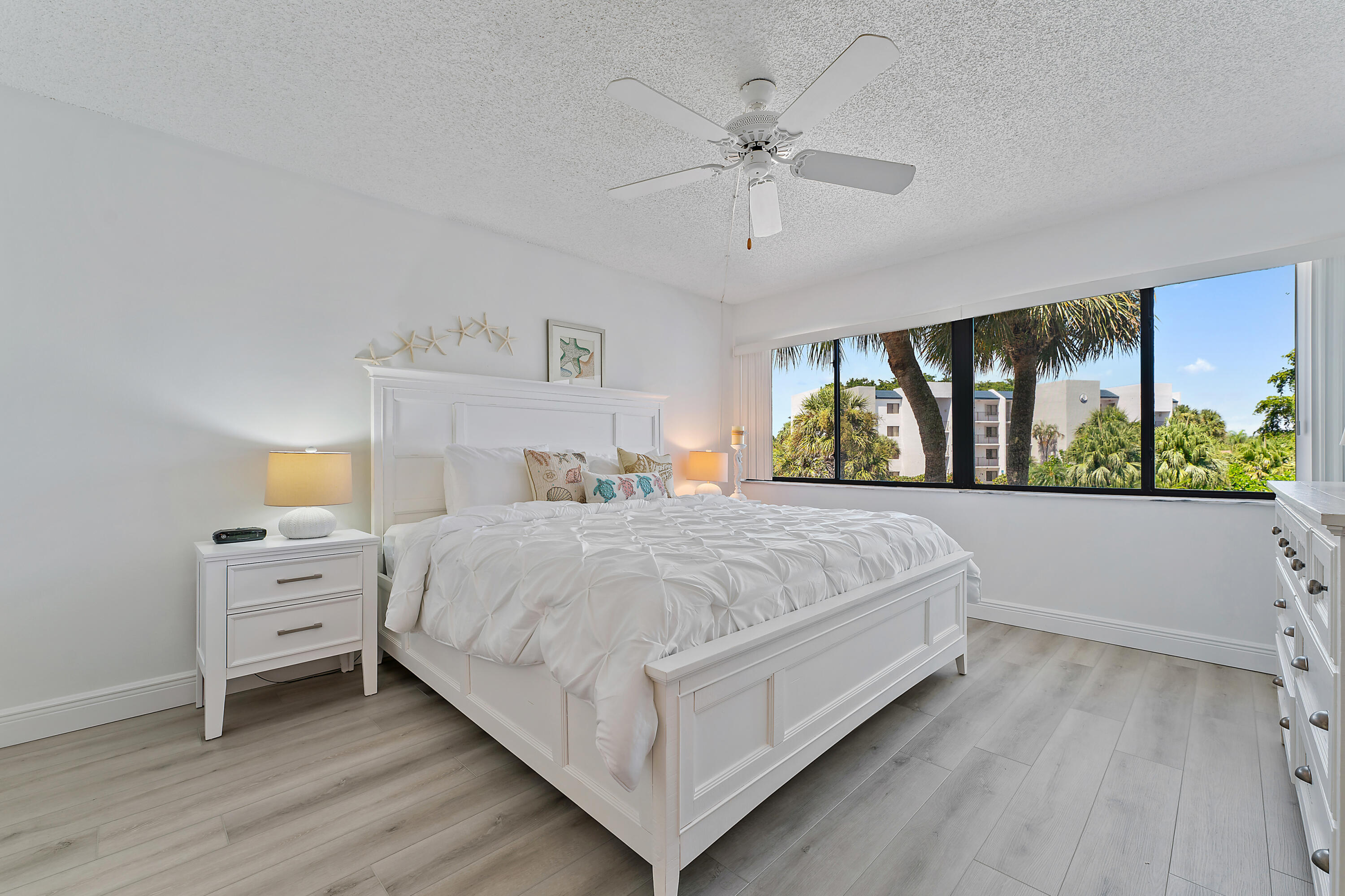 1605 Highway 1, Unit B201 Jupiter, FL 33477 - Photo 17 of 33 a bedroom with a large bed and a window