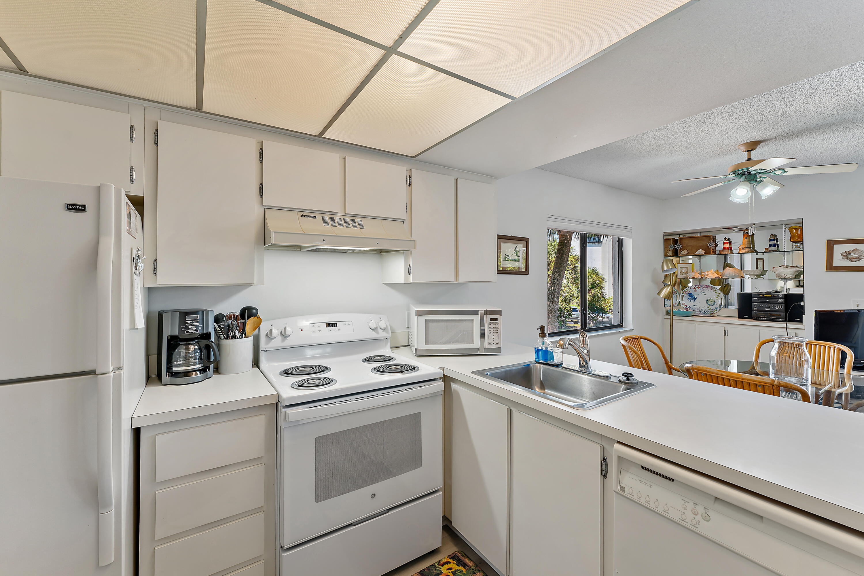 1605 Highway 1, Unit B201 Jupiter, FL 33477 - Photo 23 of 33 a kitchen with stainless steel appliances white cabinets and a stove top oven