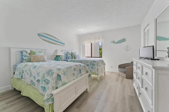 a spacious bedroom with a bed and a dresser