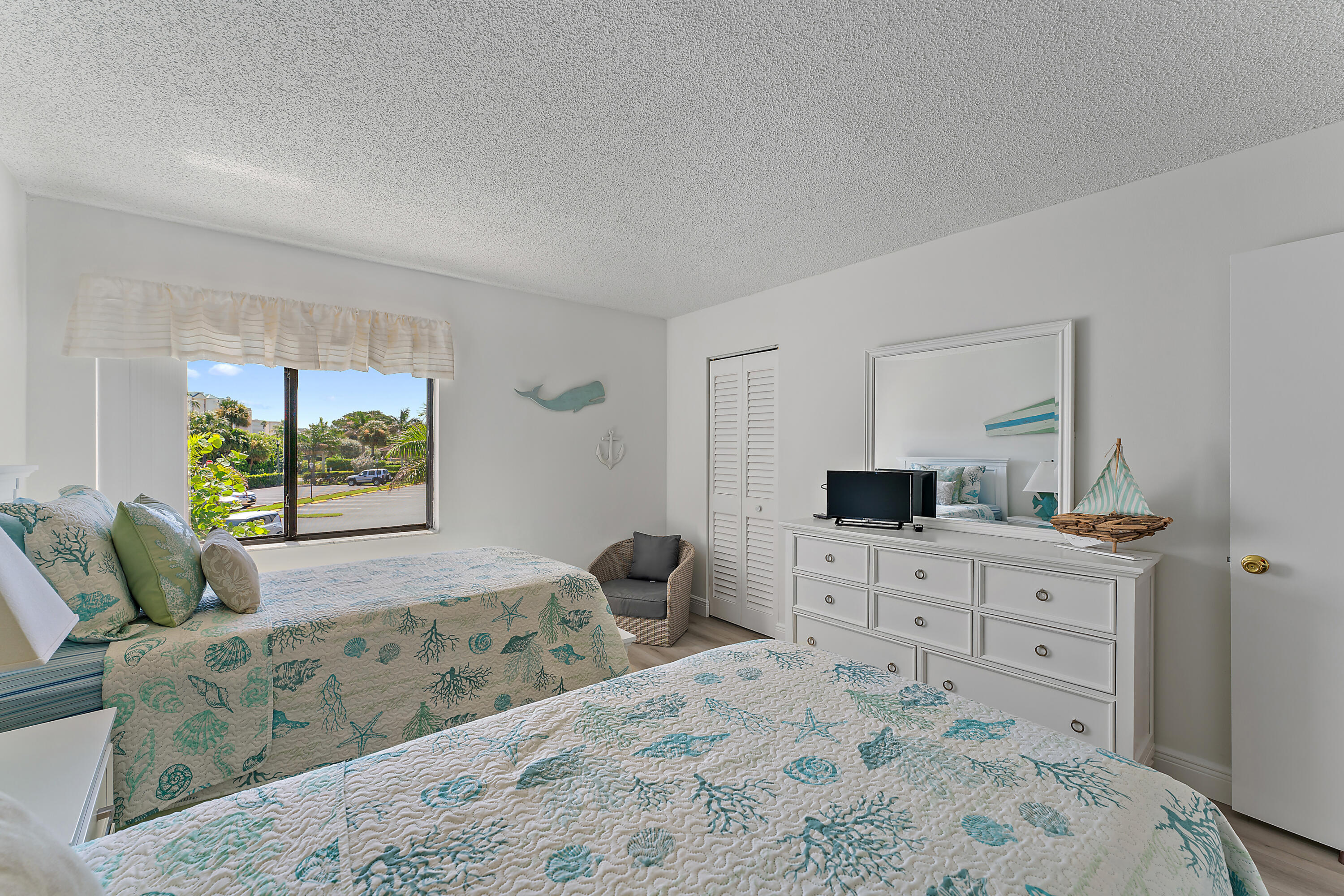 1605 Highway 1, Unit B201 Jupiter, FL 33477 - Photo 26 of 33 a bedroom with a bed and a window