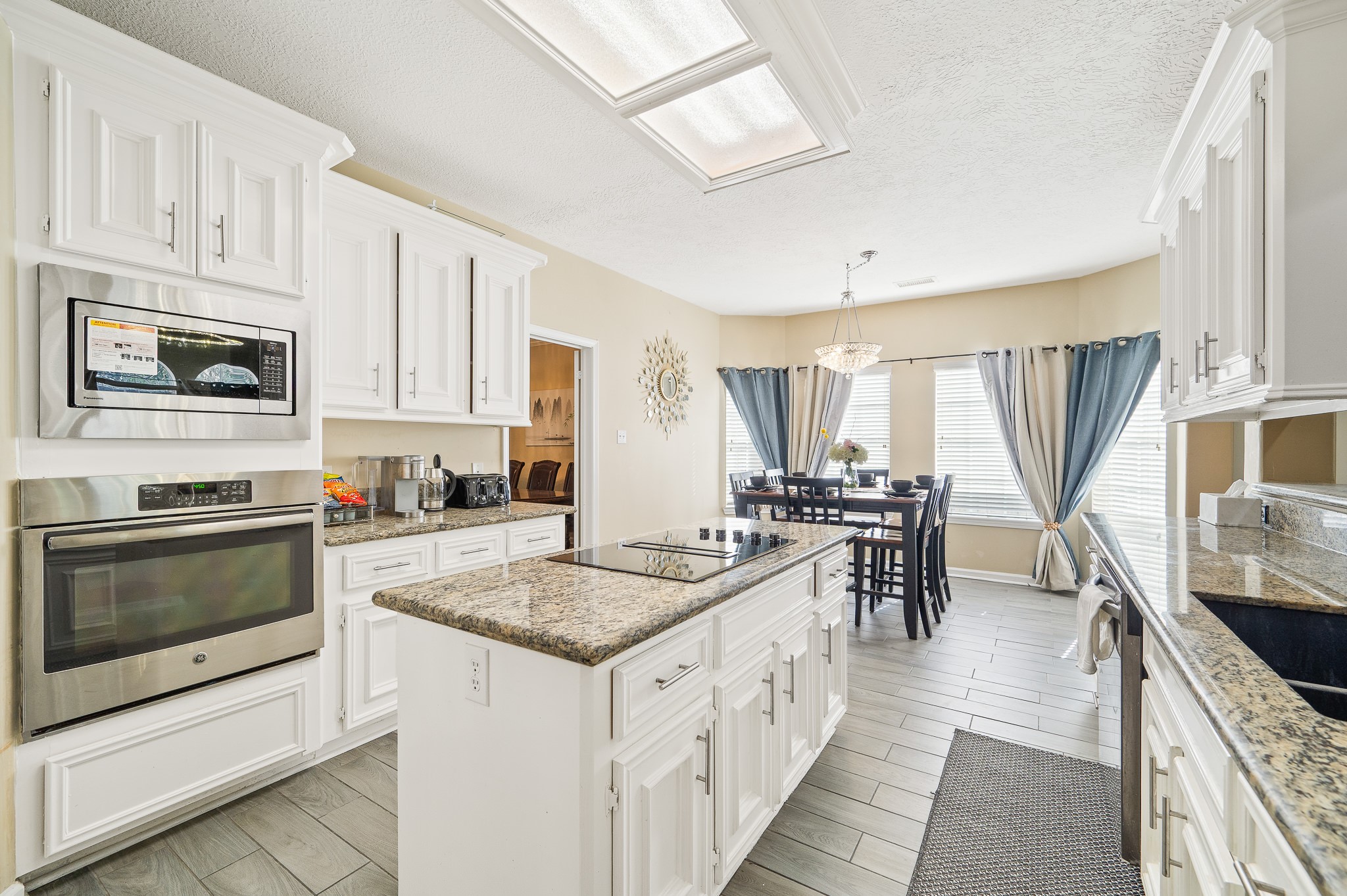 8111 Morningbrook Court Spring, TX 77379 - Photo 10 of 46 a kitchen with stainless steel appliances granite countertop a stove a sink and a microwave