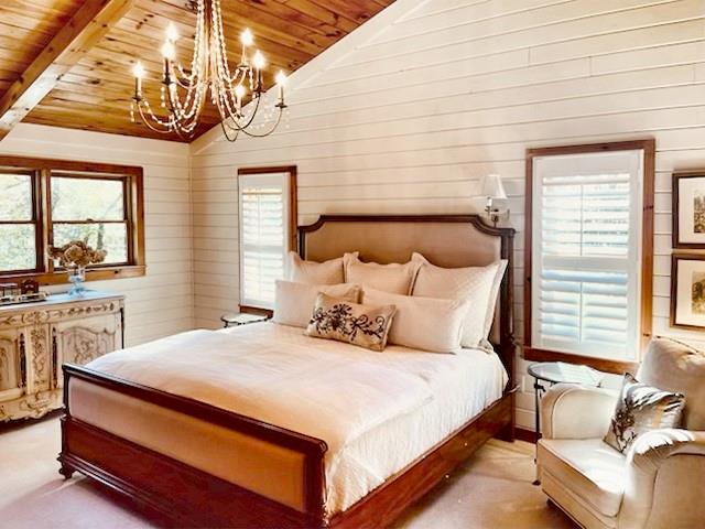 205 Minnehaha Trail Blue Ridge, GA 30513 - Photo 15 of 20 a bedroom with a large bed and a chandelier