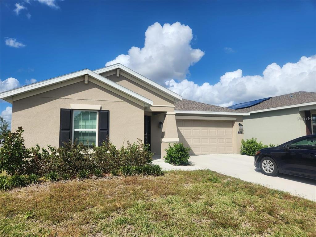 202 Brave Road Davenport, FL 33837 - Photo 1 of 17 a front view of a house with garden