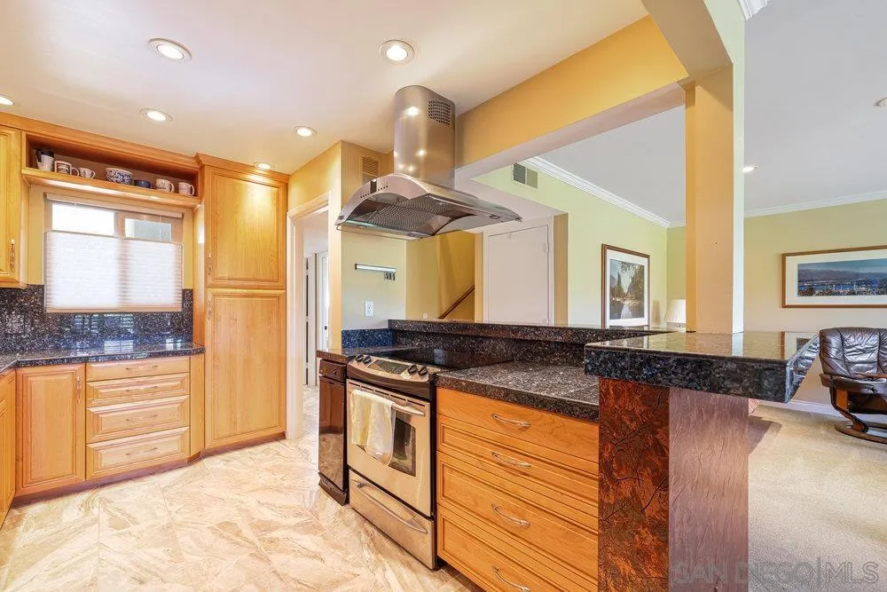 a kitchen with stainless steel appliances granite countertop a stove and a sink