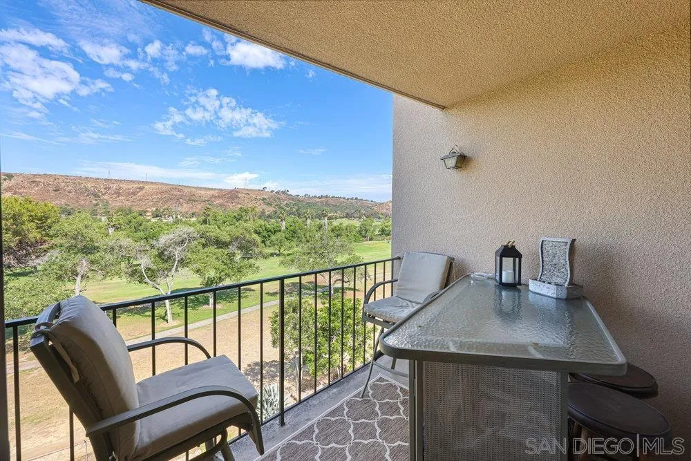 6780 Mission Gorge Road, Unit 12 San Diego, CA 92120 - Photo 13 of 23 a view of a balcony with a table and chairs