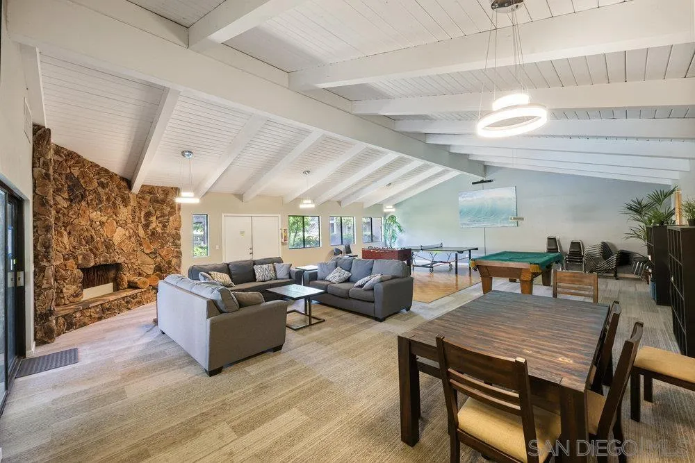 6780 Mission Gorge Road, Unit 12 San Diego, CA 92120 - Photo 21 of 23 a living room with fireplace furniture and a large window