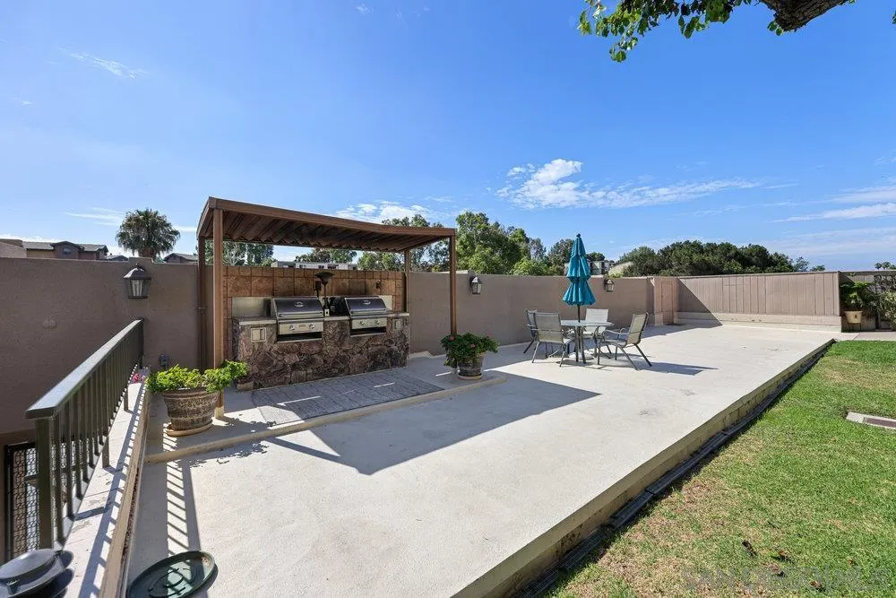 6780 Mission Gorge Road, Unit 12 San Diego, CA 92120 - Photo 22 of 23 a view of a backyard with sitting area