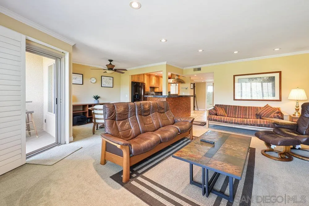 6780 Mission Gorge Road, Unit 12 San Diego, CA 92120 - Photo 4 of 23 a living room with furniture and a table
