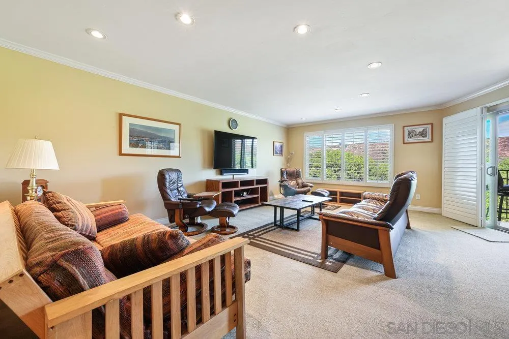 6780 Mission Gorge Road, Unit 12 San Diego, CA 92120 - Photo 5 of 23 a living room with furniture and a flat screen tv