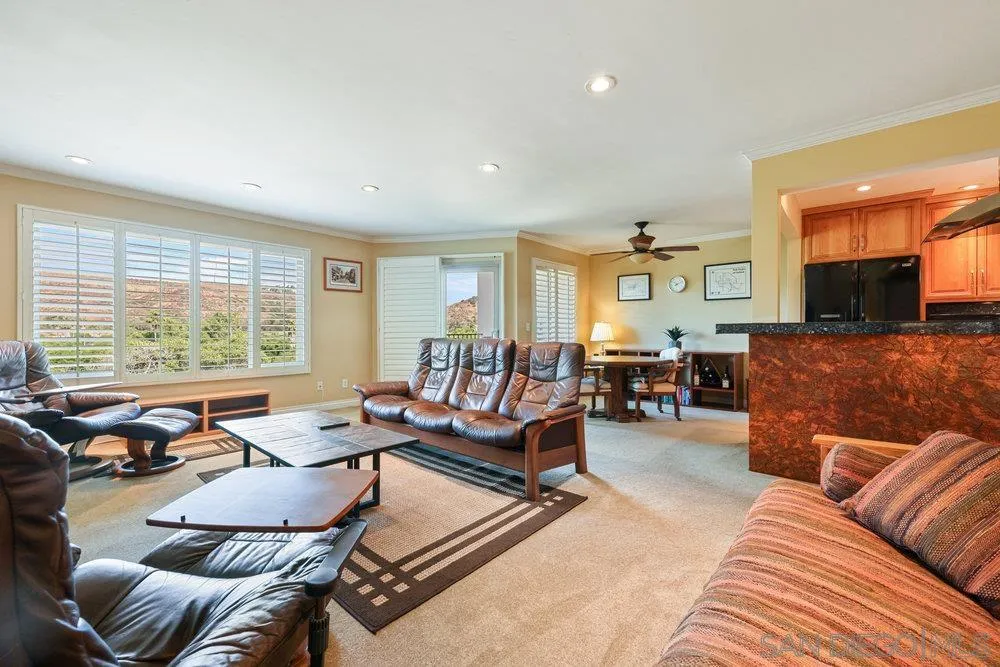 6780 Mission Gorge Road, Unit 12 San Diego, CA 92120 - Photo 6 of 23 a living room with furniture and a large window