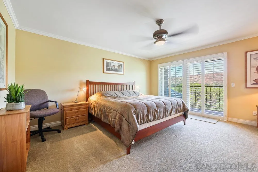 6780 Mission Gorge Road, Unit 12 San Diego, CA 92120 - Photo 7 of 23 a spacious bedroom with a bed and a desk