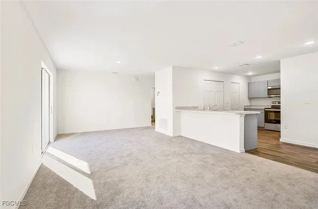 a view of a kitchen with a sink and cabinets