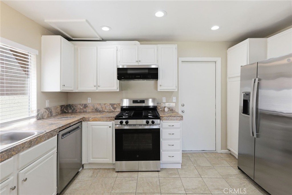 1420 Timberlane Drive Riverside, CA 92506 - Photo 15 of 61 a kitchen with stainless steel appliances granite countertop a stove a refrigerator and a sink