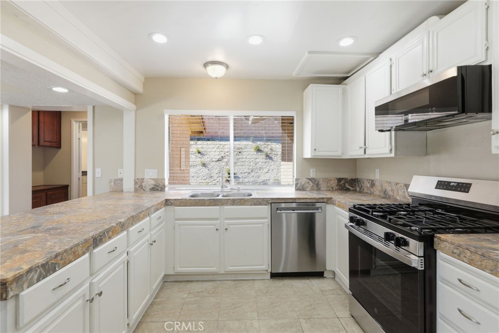 1420 Timberlane Drive Riverside, CA 92506 - Photo 16 of 61 a kitchen with stainless steel appliances granite countertop a sink and a stove