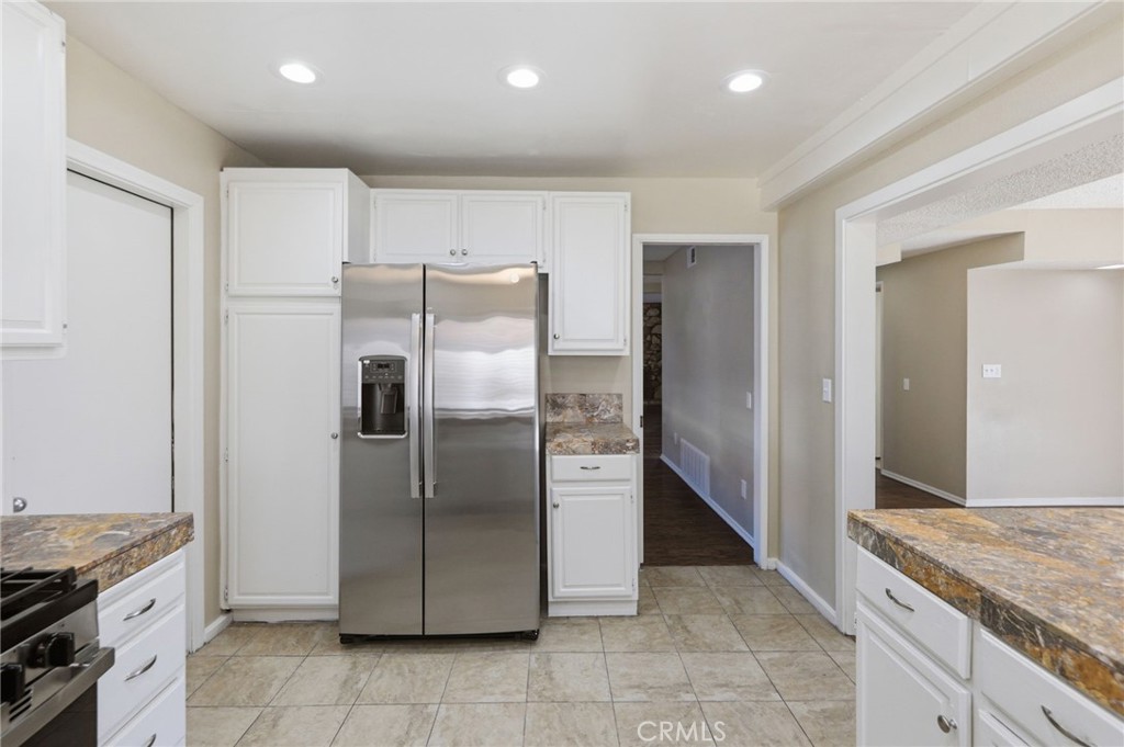 1420 Timberlane Drive Riverside, CA 92506 - Photo 18 of 61 a kitchen with stainless steel appliances granite countertop a refrigerator and a sink