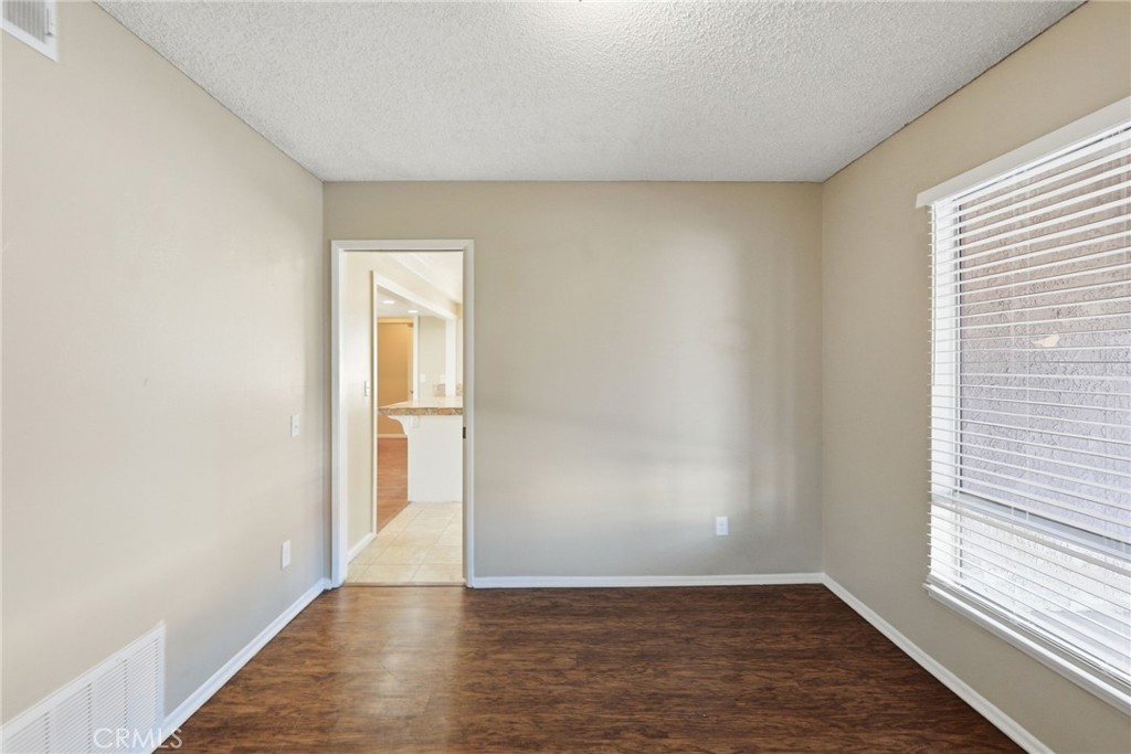 1420 Timberlane Drive Riverside, CA 92506 - Photo 19 of 61 a view of an empty room with wooden floor and a window