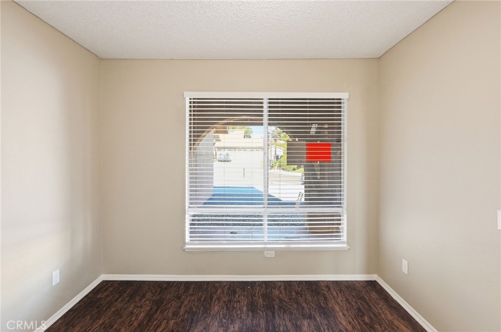 1420 Timberlane Drive Riverside, CA 92506 - Photo 20 of 61 a view of an empty room with wooden floor and a window