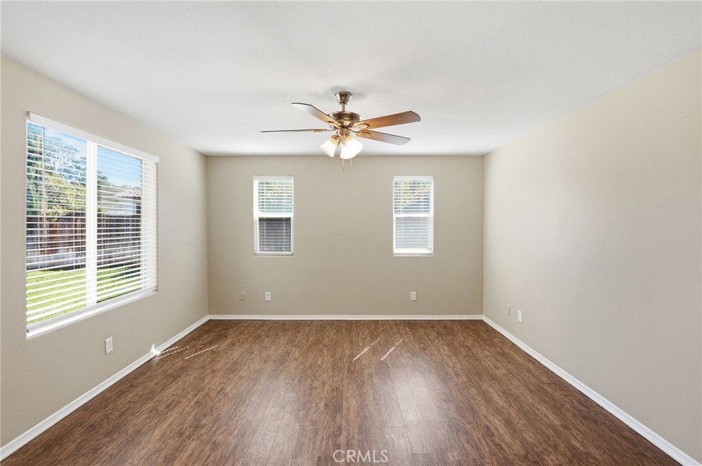 1420 Timberlane Drive Riverside, CA 92506 - Photo 21 of 61 an empty room with wooden floor and windows
