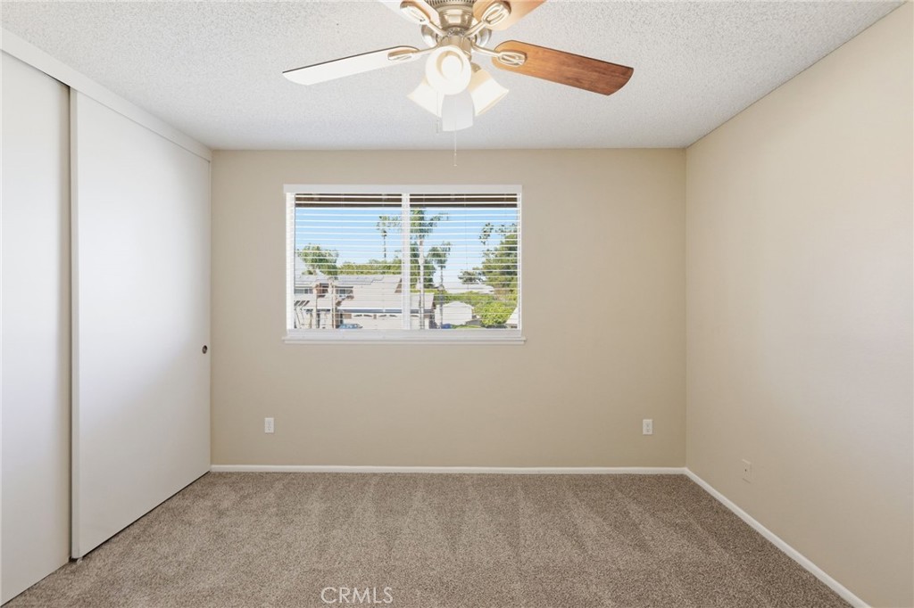 1420 Timberlane Drive Riverside, CA 92506 - Photo 24 of 61 an empty room with windows and fan