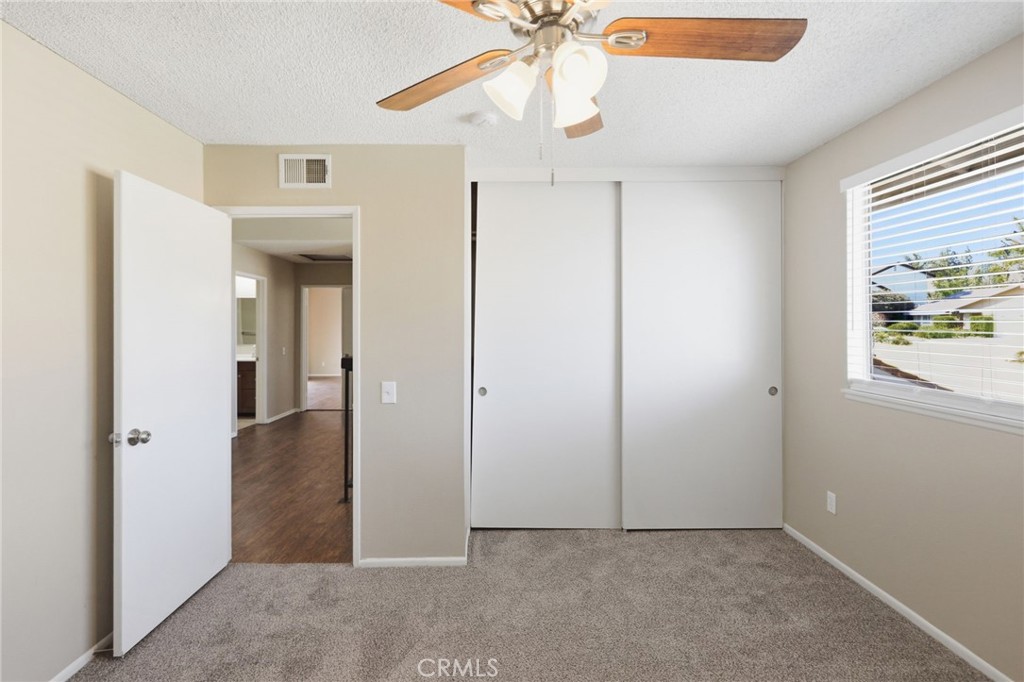 1420 Timberlane Drive Riverside, CA 92506 - Photo 25 of 61 an empty room with windows and fan