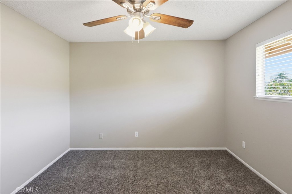 1420 Timberlane Drive Riverside, CA 92506 - Photo 31 of 61 an empty room with windows and fan