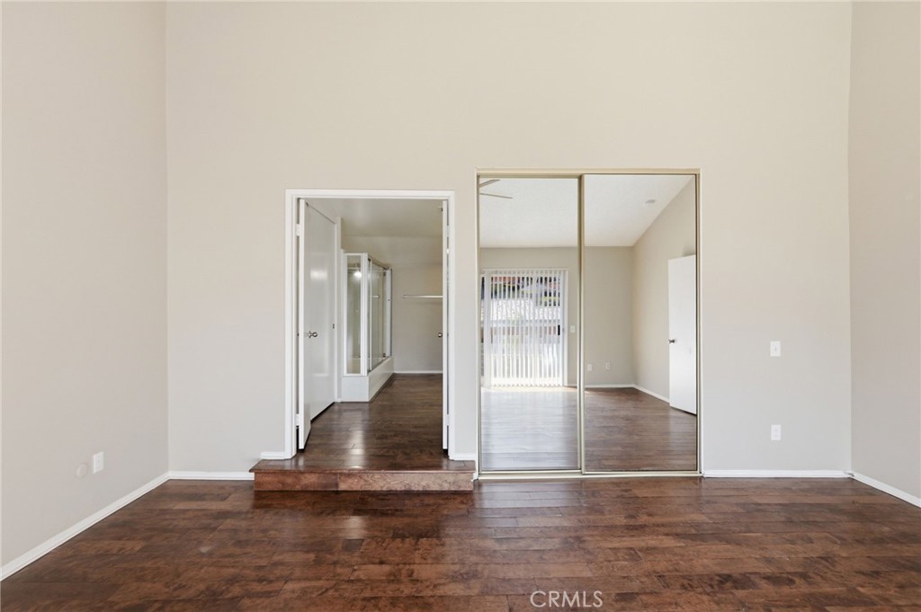 1420 Timberlane Drive Riverside, CA 92506 - Photo 37 of 61 an empty room with wooden floor and a rug