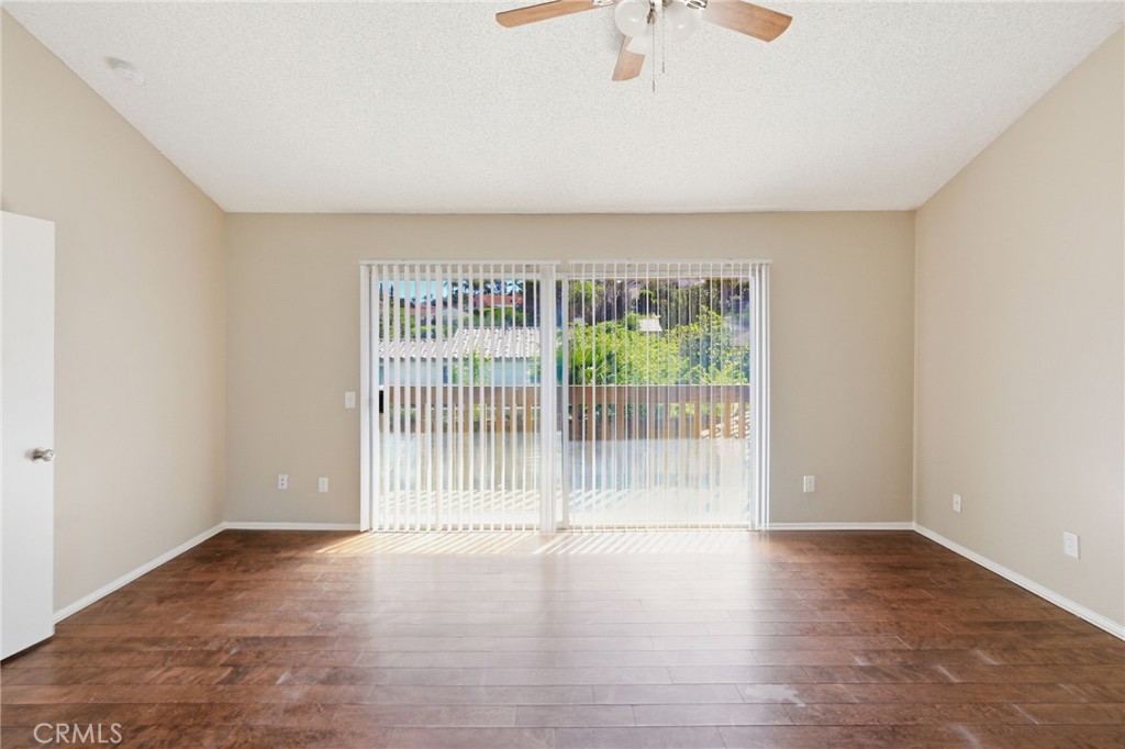 1420 Timberlane Drive Riverside, CA 92506 - Photo 39 of 61 an empty room with wooden floor and windows