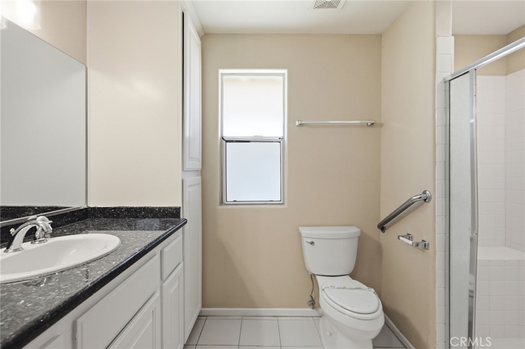 1420 Timberlane Drive Riverside, CA 92506 - Photo 40 of 61 a bathroom with a granite countertop sink toilet and shower