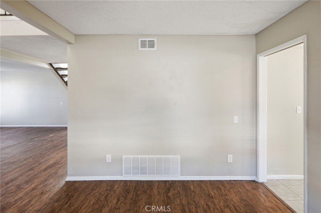 1420 Timberlane Drive Riverside, CA 92506 - Photo 4 of 61 an empty room with wooden floor and cabinet