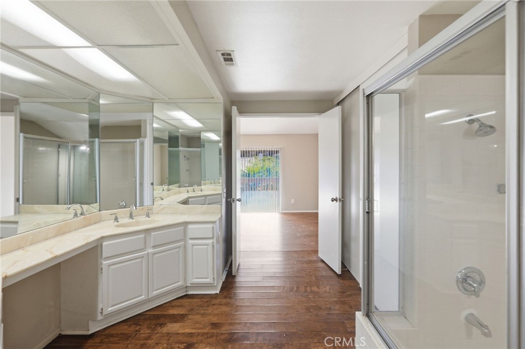 1420 Timberlane Drive Riverside, CA 92506 - Photo 45 of 61 a large bathroom with a glass door shower a sink and mirror