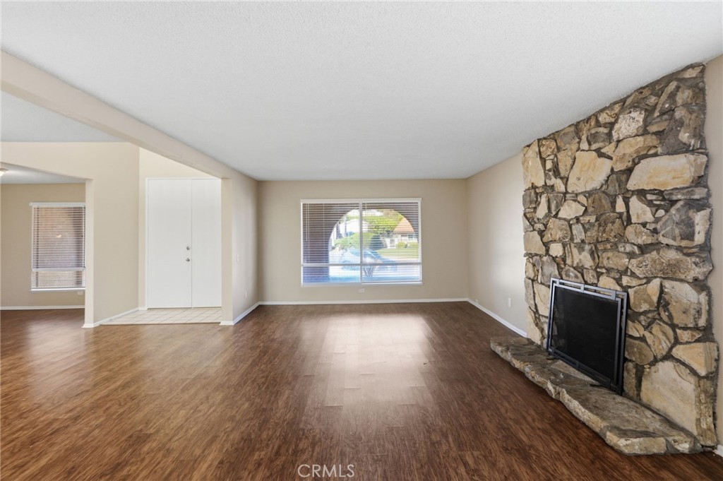 1420 Timberlane Drive Riverside, CA 92506 - Photo 8 of 61 an empty room with wooden floor and fireplace
