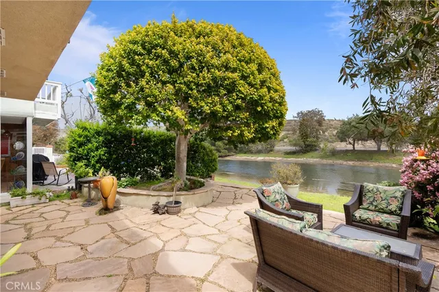 a view of backyard with outdoor seating and plants