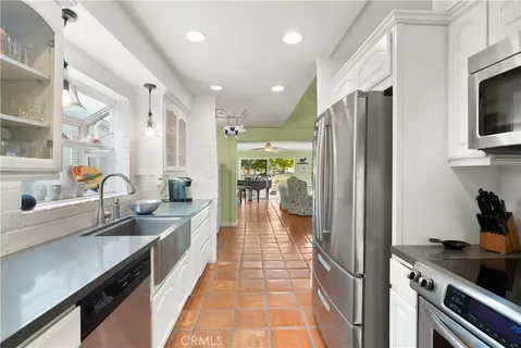 a kitchen with stainless steel appliances a refrigerator and a sink