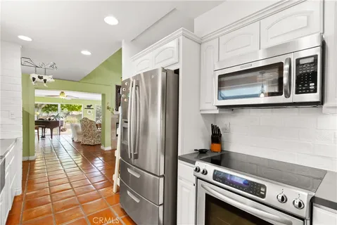 a dining room with furniture and a floor to ceiling window