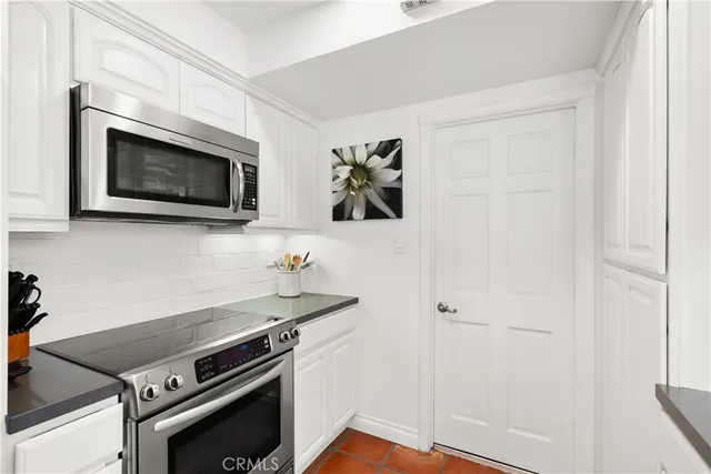 a kitchen with stainless steel appliances a refrigerator and a sink