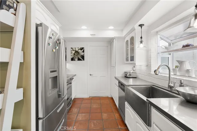 a dining room with furniture and a floor to ceiling window