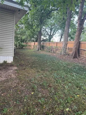 a view of a yard with a tree